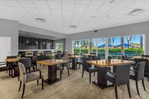 a dining room with tables and chairs and windows at 3 Bedrooms 25 Bathrooms Encantada 3091 Yl in Orlando