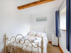 a bedroom with a white bed and blue curtains at Beautiful 3 Bedroom Cottage -Cottage 5 in Doncaster