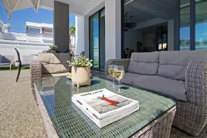 a table with a wine glass and a book on it at Villa Martha in Protaras