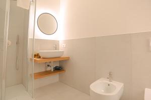 a bathroom with a sink and a toilet and a mirror at Regina di Verona - Royal Welcome in Verona