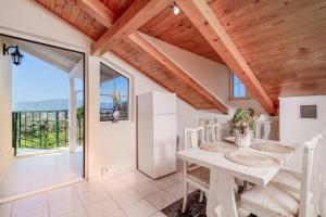 a dining room with a table and a view of the ocean at Étienne Apartment in Central Location in Zakynthos