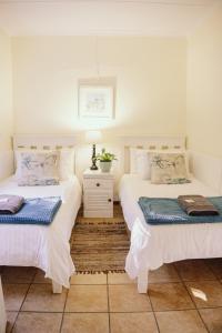 two beds sitting next to each other in a room at Redberry Farm in George