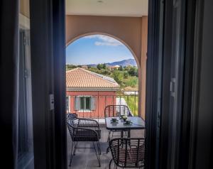 a view of a balcony with a table and chairs at Villas Thalia in Zakynthos