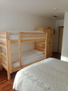 a bedroom with two bunk beds in a room at Oberthaler Hotel in Sappada