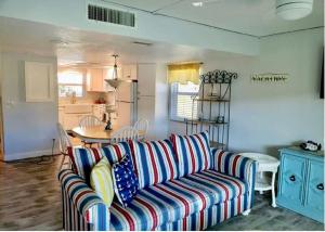 a living room with a couch and a table at Condo By The Sea! in Cocoa Beach