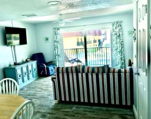 a living room with a couch and a table at Condo By The Sea! in Cocoa Beach