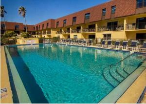 a large swimming pool in front of a hotel at Condo By The Sea! in Cocoa Beach