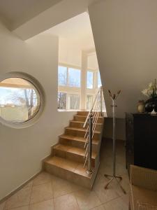 a staircase in a house with a round window at Villa Sutomore in Sutomore