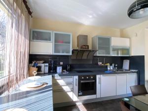 a kitchen with white cabinets and a stove top oven at Villa Sutomore in Sutomore +48 photos