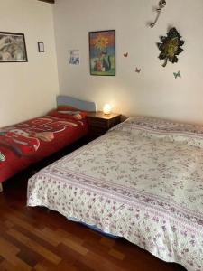 a bedroom with two beds in a room at La tana alla Costa di Sessa in Sessa