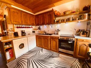 a kitchen with a zebra patterned floor at Chalet Savoyard avec Cheminée et Parking à Samoëns - FR-1-624-80 in Samoëns +7 photos
