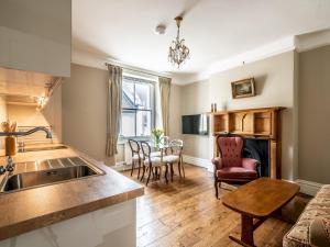 a kitchen and living room with a sink and a table at Pass the Keys Characterful period home in heart of Chagford in Chagford