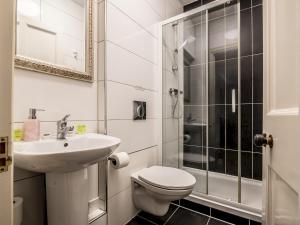 a bathroom with a toilet and a sink and a shower at Pass the Keys Characterful period home in heart of Chagford in Chagford