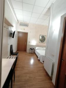 a hospital room with two beds and a hallway at Hotel Julia in Rome