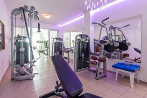 a gym with a bunch of machines in a room at Sunshine Village Hotel in Hersonissos