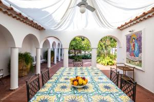a dining room with a table with a bowl of fruit on it at Estate4home - Villa Bouganville in Massa Lubrense