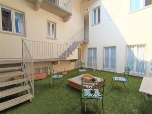 a room with chairs and a table and stairs at Antica Stresa in Stresa