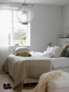 a white bedroom with a bed and a window at Ennishmore Mews Apartment in London
