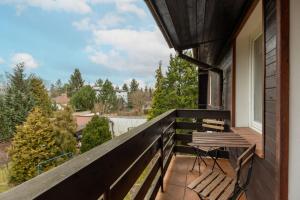 a balcony with a bench on a house at Quiet Bemowo House with Garden by Renters in Warsaw