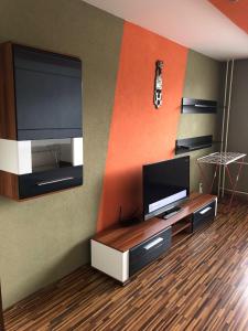 a living room with a flat screen tv on a wall at Apartman Gufo in Kysucké Nové Mesto