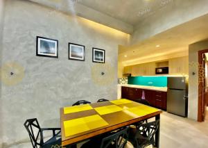 a kitchen with a table with yellow squares on the wall at Spacious 2 Bedroom perfect for Family & Friends, Good for 4pax allows to stay 10pax in Manila