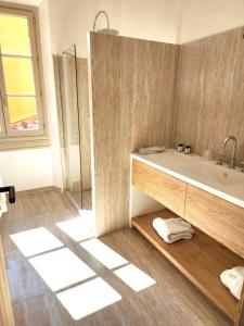 a bathroom with a sink and a glass shower at La Bastide Du Port - Hôtel de Charme in Saint-Tropez