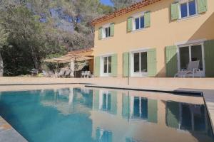 a swimming pool in front of a house at VILLA DES COLLINES - Absolute calm at 10' from the center in Antibes