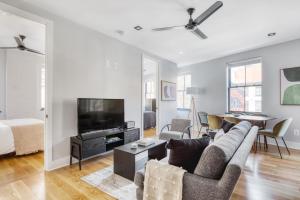 a living room with a couch and a tv at West Village 3br w wd nr Pier 46 NYC-1098 in New York