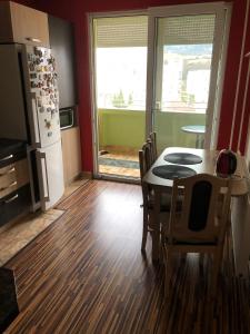 a kitchen with a table and chairs and a refrigerator at Apartman Gufo in Kysucké Nové Mesto