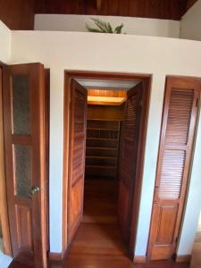 a hallway with two doors and a closet at Casa Mora B&B in Cartago