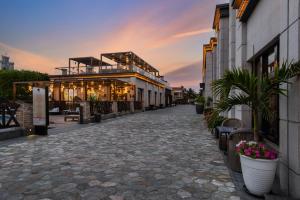 a cobblestone street in front of a building at Narcissus Obhur Resort & Spa in Jeddah