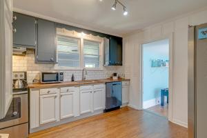 a kitchen with white cabinets and a microwave at The Titan - Pet-friendly Bungalow in Nashville