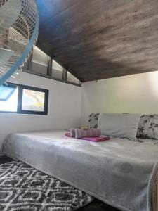 Postel nebo postele na pokoji v ubytování Tupi's Beachfront Minihouse + 32 fotografií
