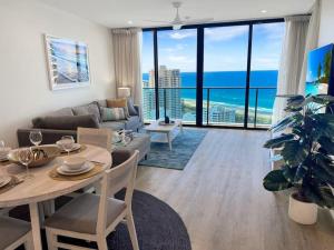 a living room with a couch and a table at 29th floor Oracle Tower 2 stunning ocean and city views in Gold Coast