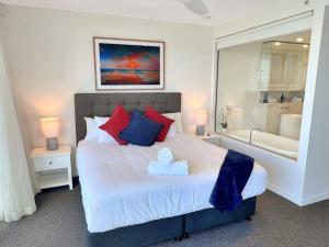 a bedroom with a large bed and a bath tub at 29th floor Oracle Tower 2 stunning ocean and city views in Gold Coast