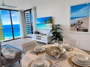 a dining room with a table and chairs and the ocean at 29th floor Oracle Tower 2 stunning ocean and city views in Gold Coast