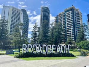 a sign that says broad beach in front of buildings at 29th floor Oracle Tower 2 stunning ocean and city views in Gold Coast