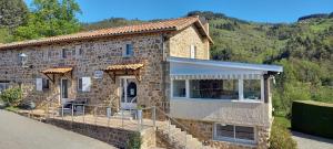 a stone house in the mountains with a pathway at Auberge Le Champêtre in Saint-Cierge-sous-le-Cheylard