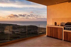 uma cozinha com vista para o oceano em Lighthouse View Apartment em Żebbuġ