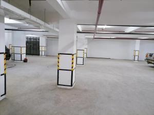 an empty parking garage with yellow and white dividers at Nash Issah Homes-1BedRoom in Nakuru