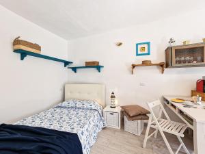 a bedroom with a bed and a desk and a table at Loft Francesca Old City Center in Rio Marina