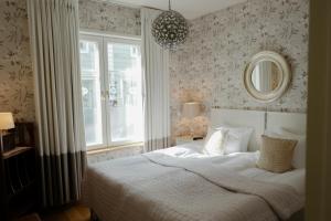 1 dormitorio con cama blanca y ventana en Pariisin Ville, en Porvoo