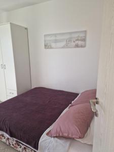 a bedroom with a bed and a picture on the wall at Marta apartment in Petrovac na Moru