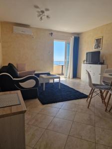 a living room with a couch and a table at Marta apartment in Petrovac na Moru