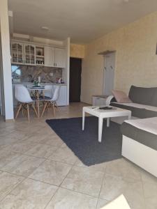 a living room with a couch and a table at Marta apartment in Petrovac na Moru +2 photos