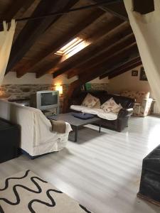 sala de estar con 2 sofás y TV en VILLA junto a la Ría del Eo, en CASTROPOL Asturias, en Castropol