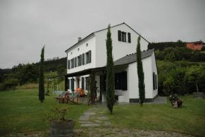 una casa blanca con una mesa y sillas en un patio en VILLA junto a la Ría del Eo, en CASTROPOL Asturias, en Castropol