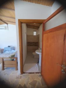 a bathroom with a toilet and a sink in a room at Artolive Datca in Datca