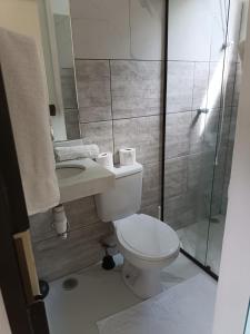 a small bathroom with a toilet and a shower at Diver Village Ilhabela in Ilhabela
