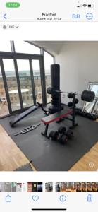 a room with a gym with a bunch of weights at Shared with Host Lister Pods Executive Penthouse in Bradford